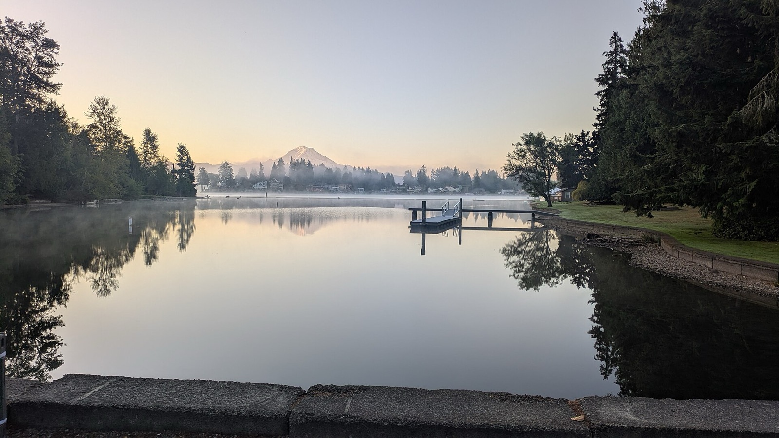 Lake Tapps at dawn, still water with Mount Rainier on the horizon